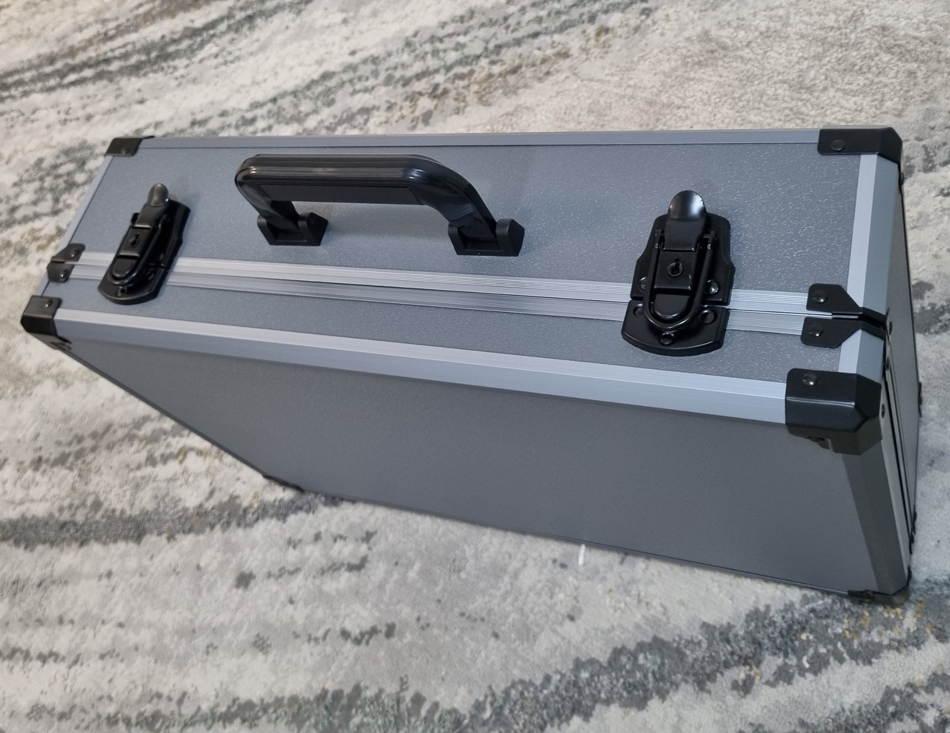 Silver and black case on a textured surface