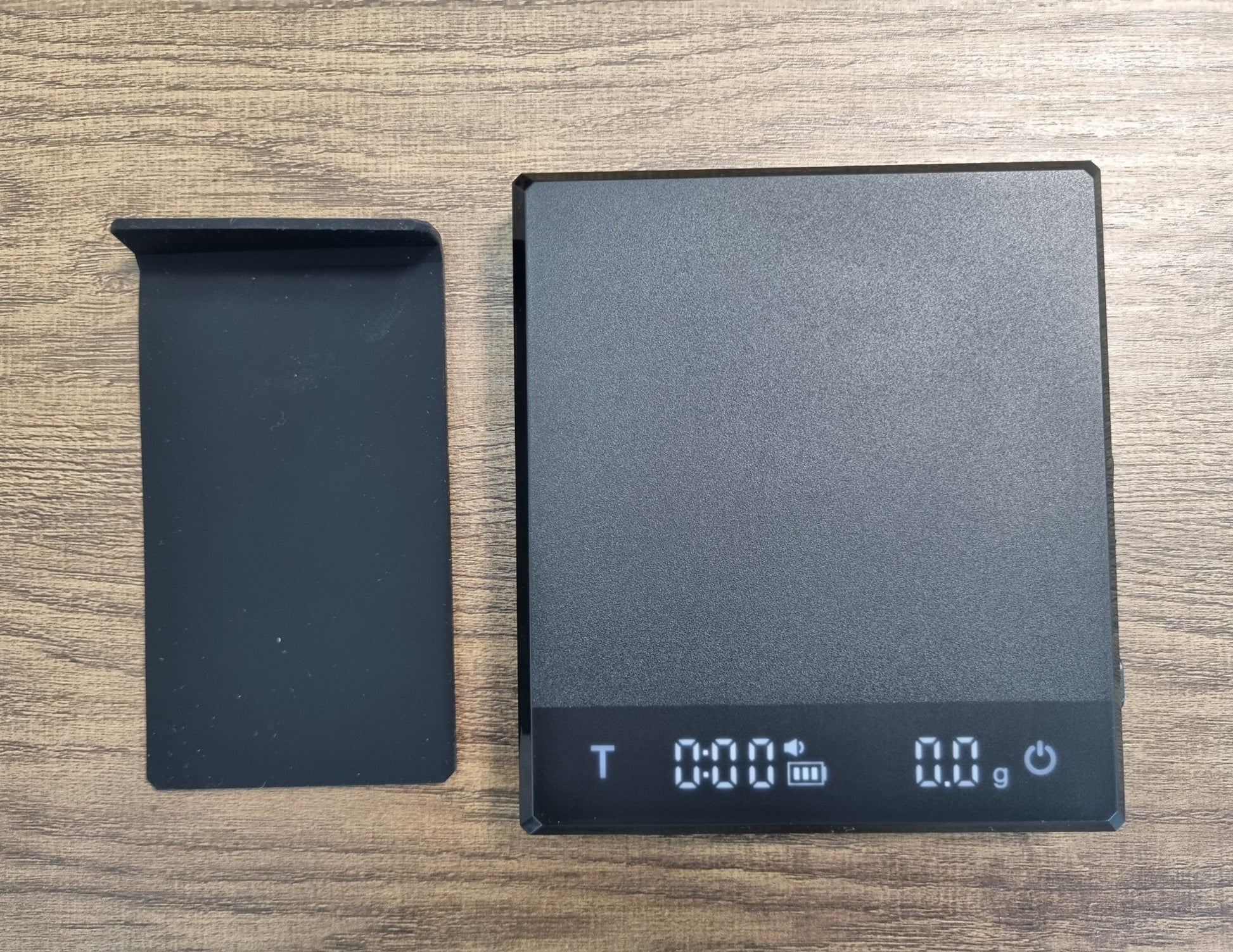 Black digital display device on a wooden surface