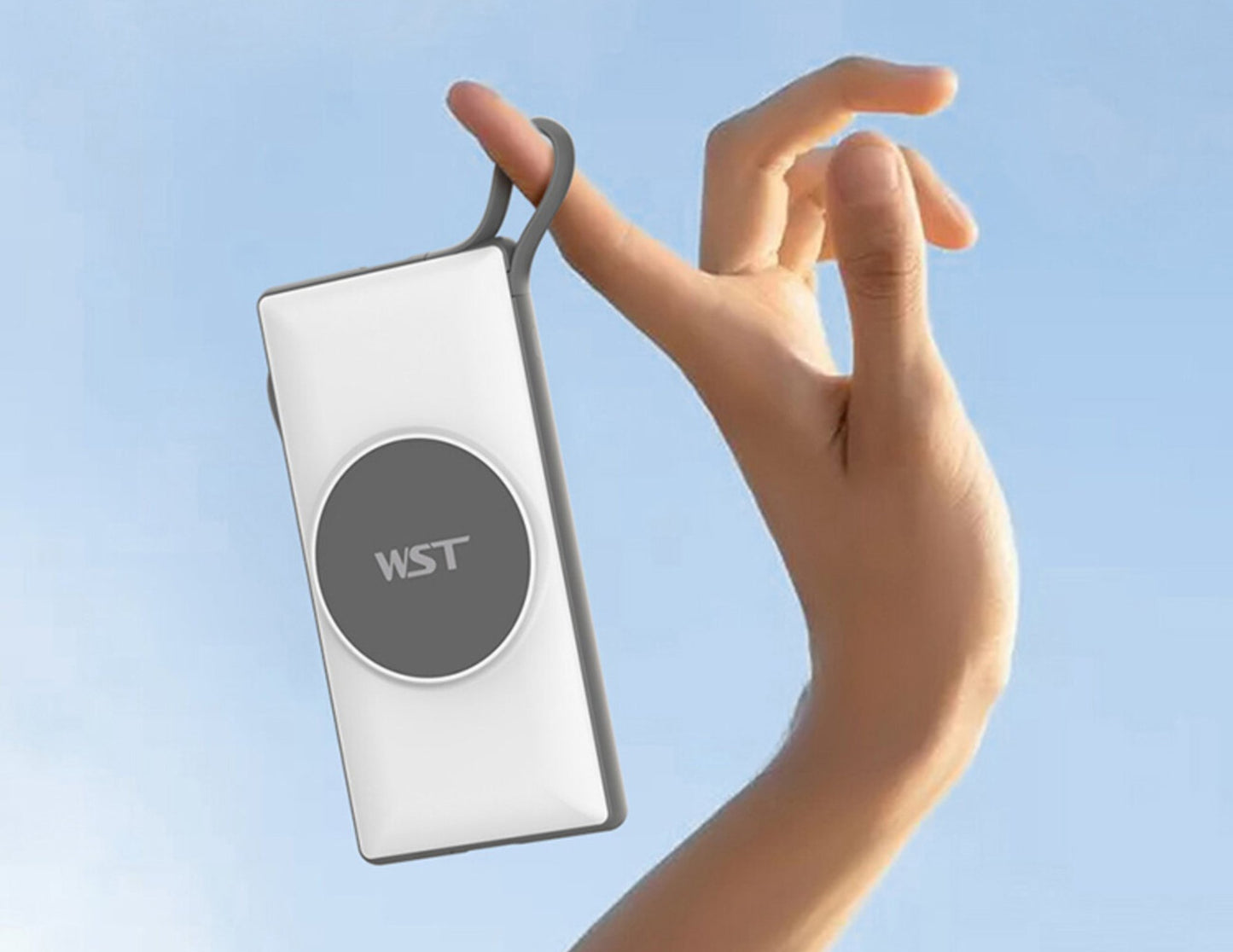 Hand holding a white rectangular device with a gray circular component against a light blue background.