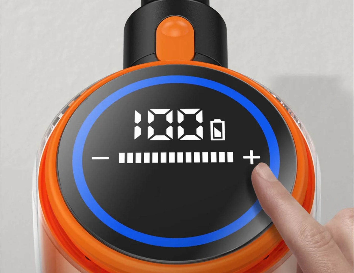 Close-up of a digital display on a device with a hand interacting with it.