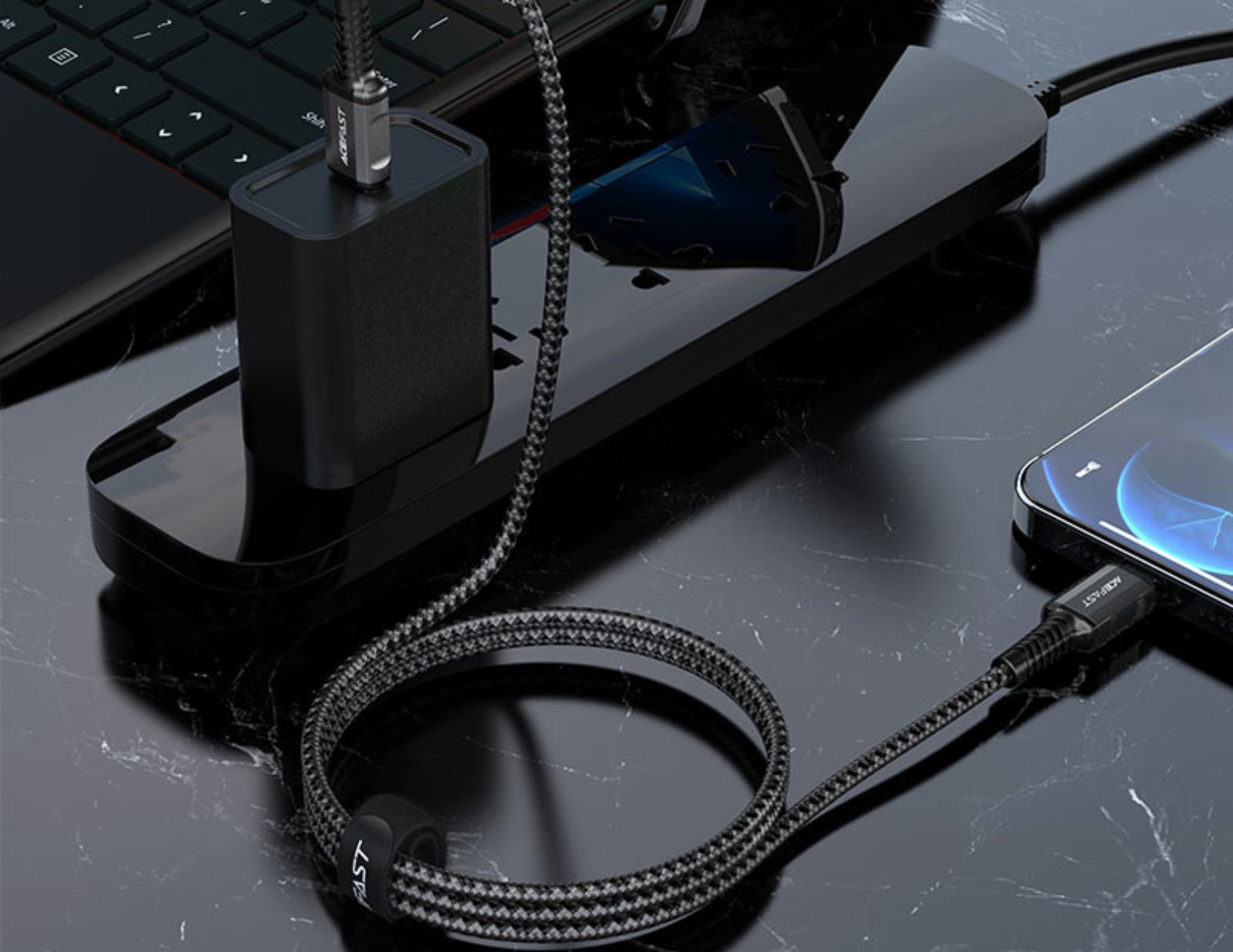 Black USB-C hub with cable on a reflective surface