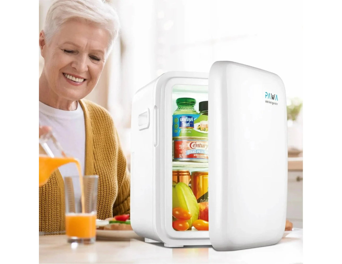 PAWA Mini Refrigerator 10L PW10LMR-WH with drinks on a table, woman in background