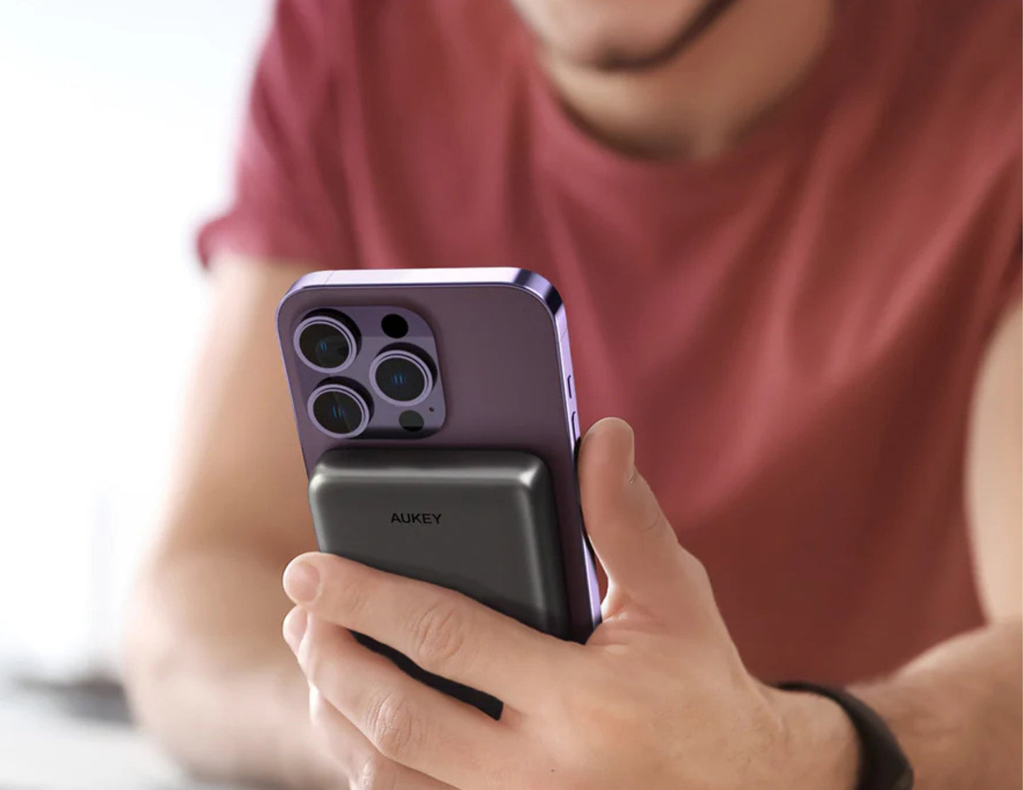 Person holding a purple smartphone with 'Huawei' branding
