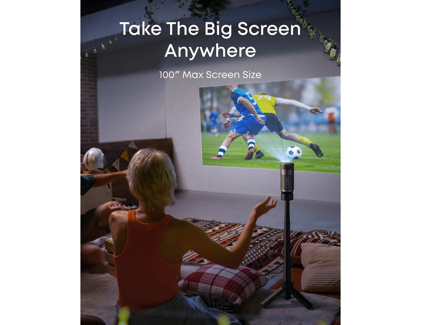 Person watching a soccer game on a Anker Nebula Capsule Air (D4112211) HD Portable Projector screen in a casual setting.