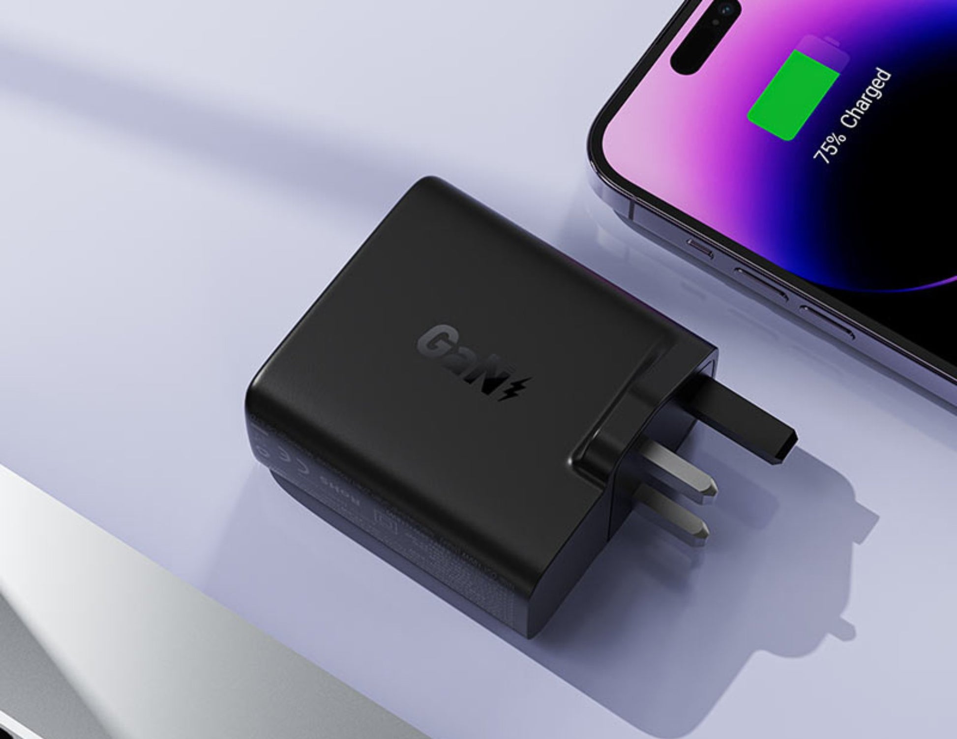 Black charging adapter with UK plug on a light gray background