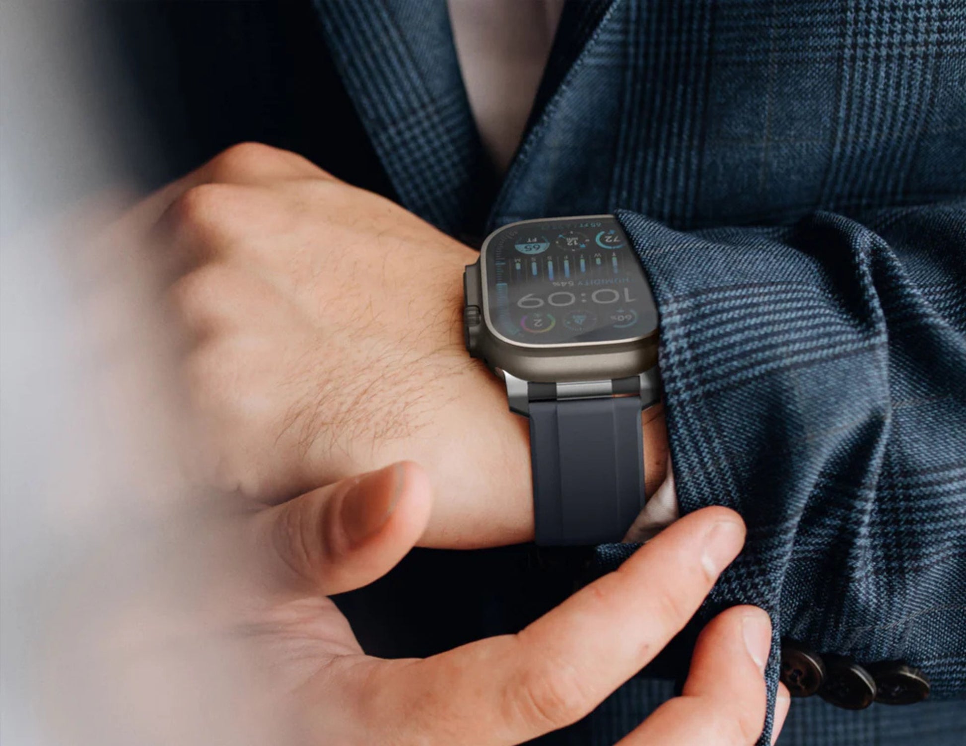 Person wearing a smartwatch on their wrist with a blurred background