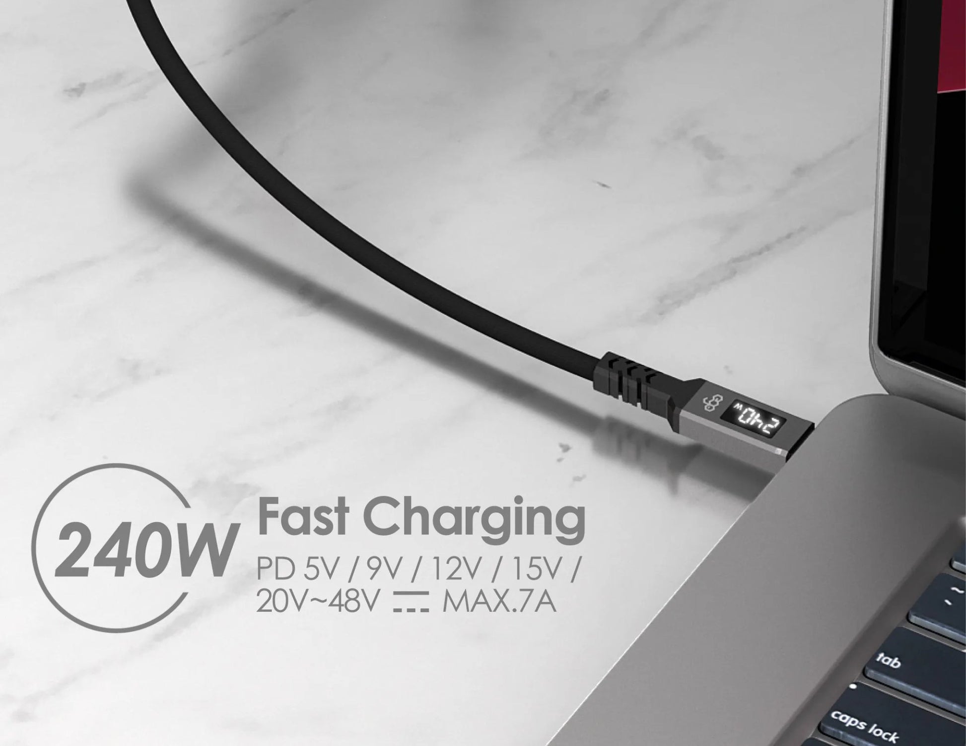 Laptop with a charging cable on a marble surface, displaying fast charging capabilities.