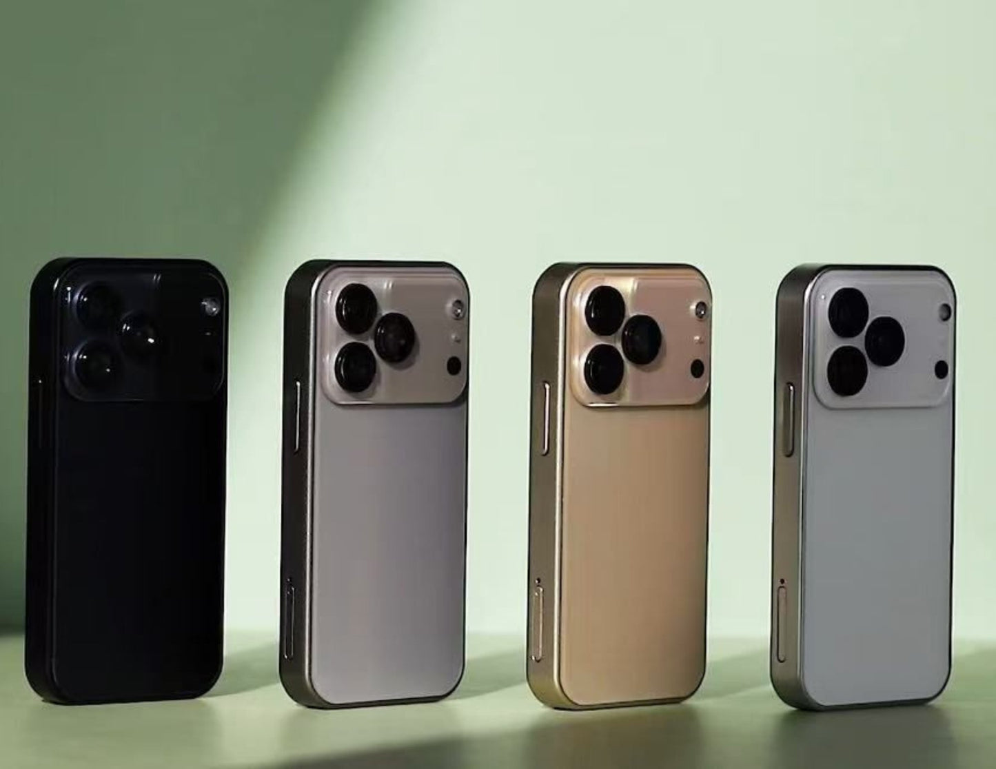 Four smartphones in black, silver, gold, and gray on a light green background