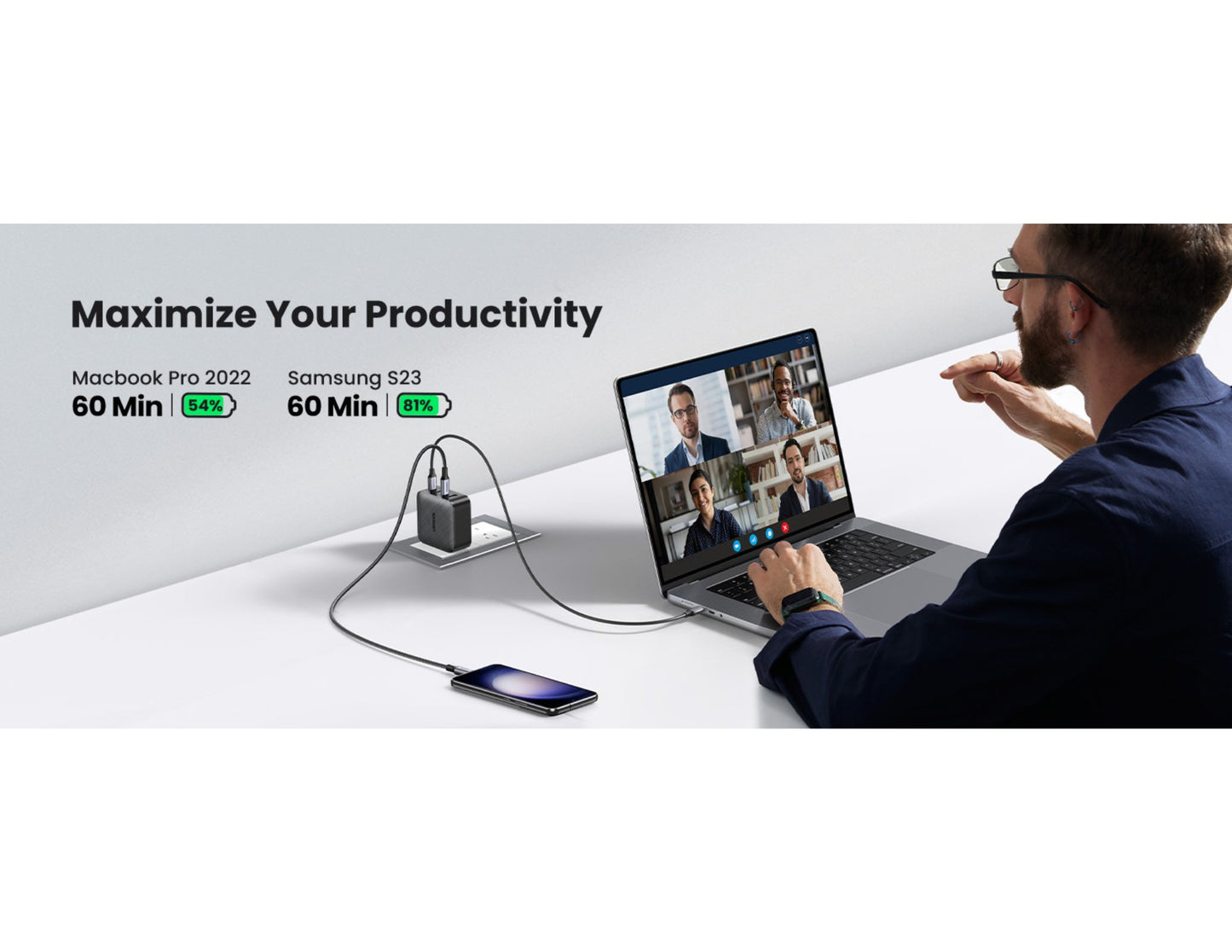 Person using a laptop with a video call on a white desk, with text about productivity and device specifications.