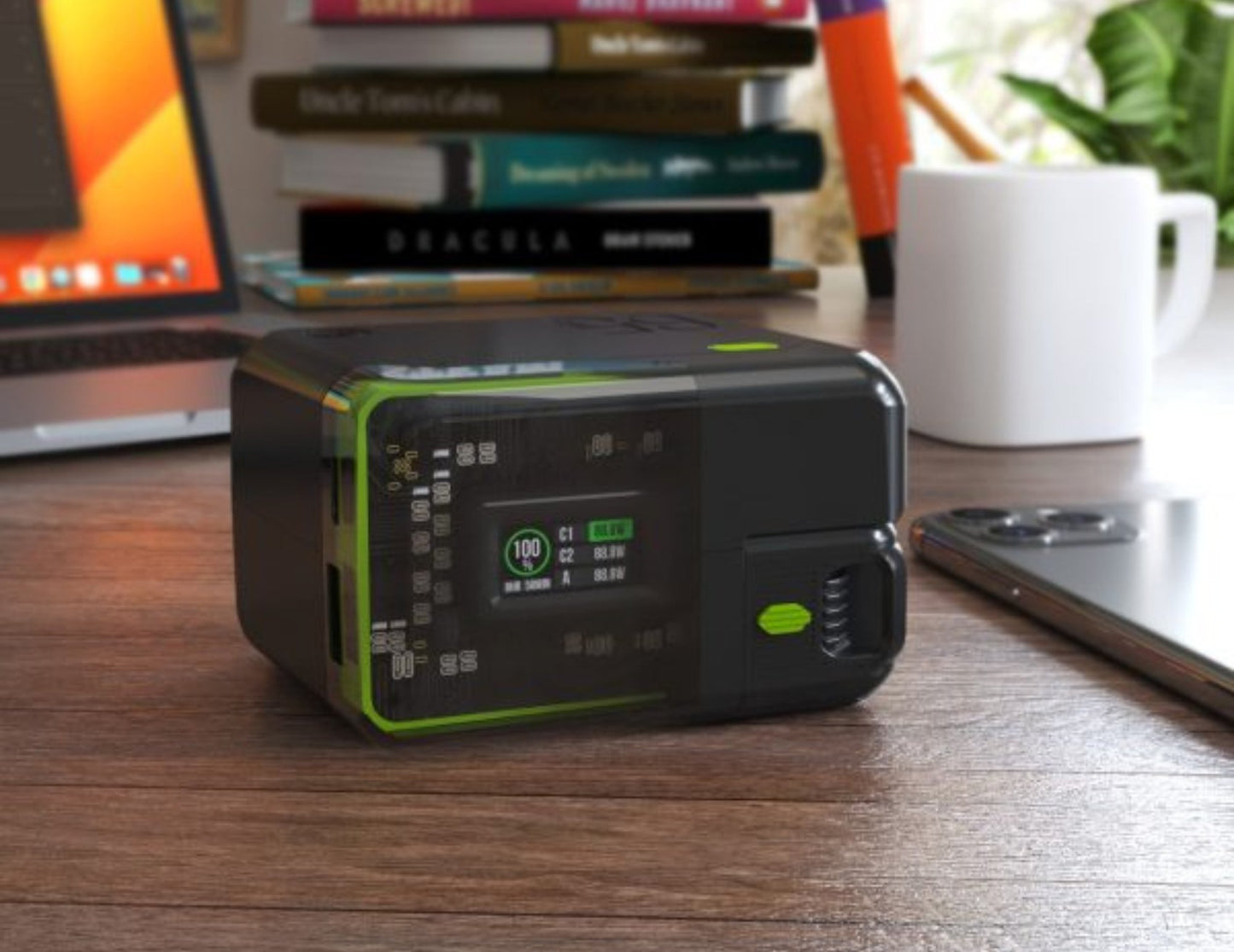 Portable power station on a desk with books and a laptop in the background