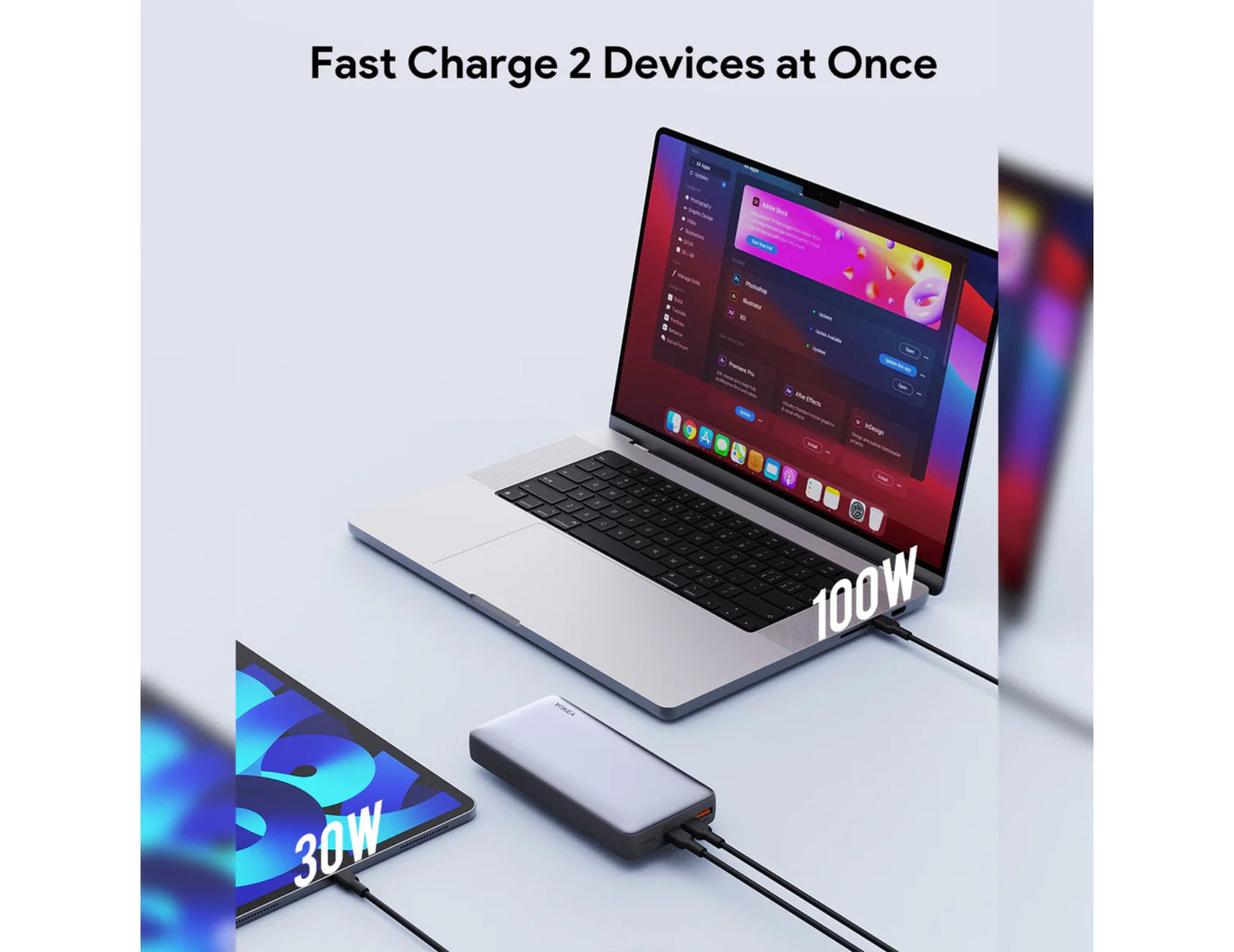 Laptop and smartphone with a Aukey PB-Y43P Sprint X 130W PD 20K mAh Fast Charging Power Bank on a light gray background, emphasizing fast charging capabilities.