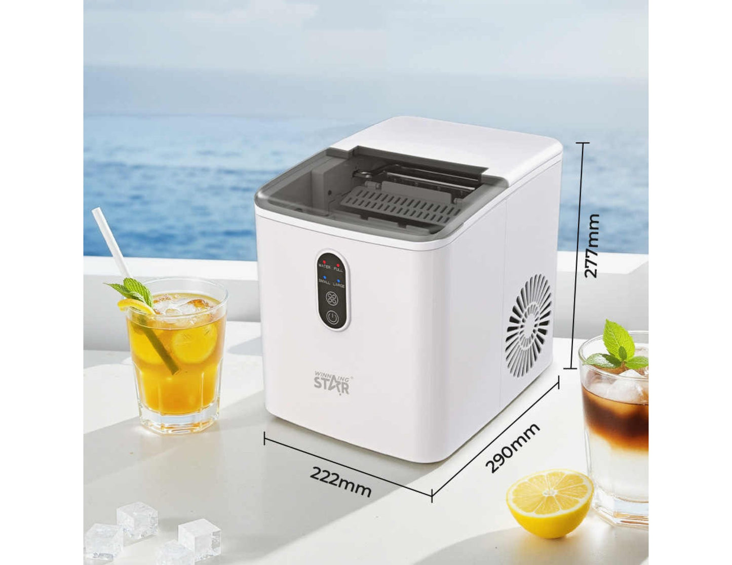 Winning Star Portable Ice Maker ST-9501 on a table with drinks and lemon slices, set against a scenic background.