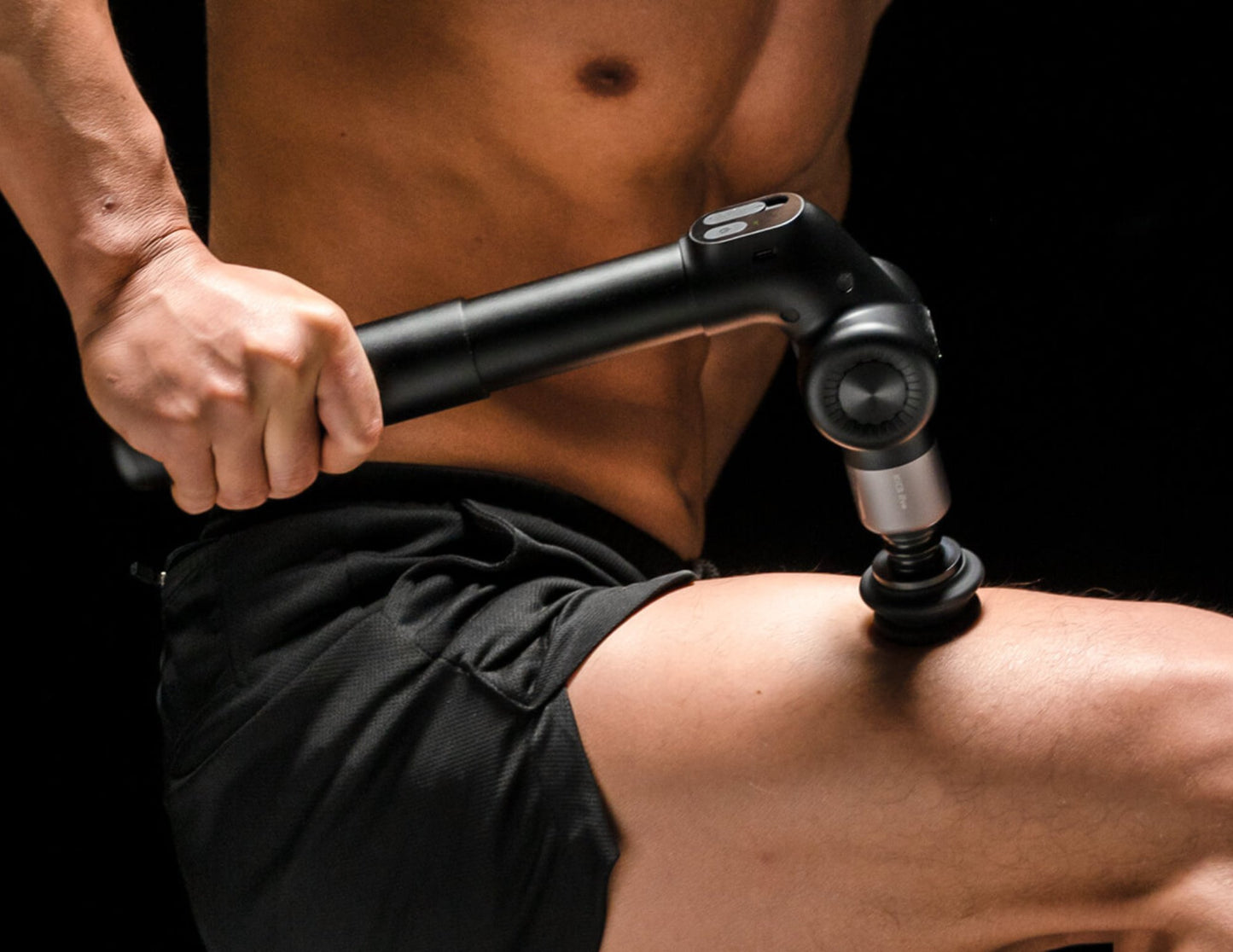 Person using a Kica Evo Fascia Massage Gun on their leg against a black background