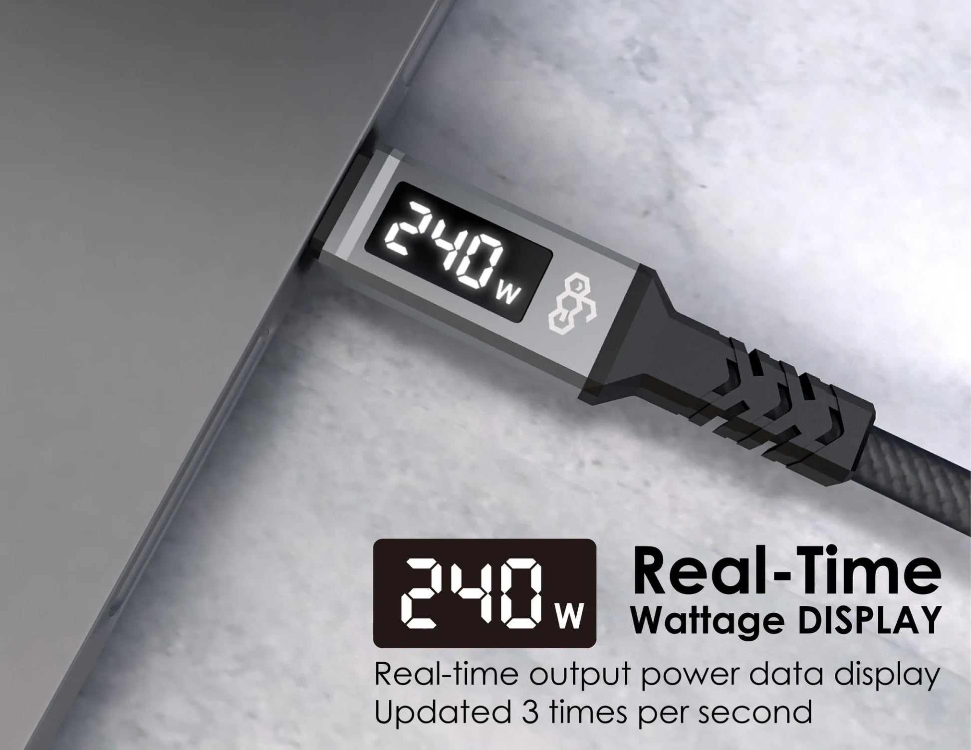 Power cable with digital display showing real-time wattage on a metallic surface.