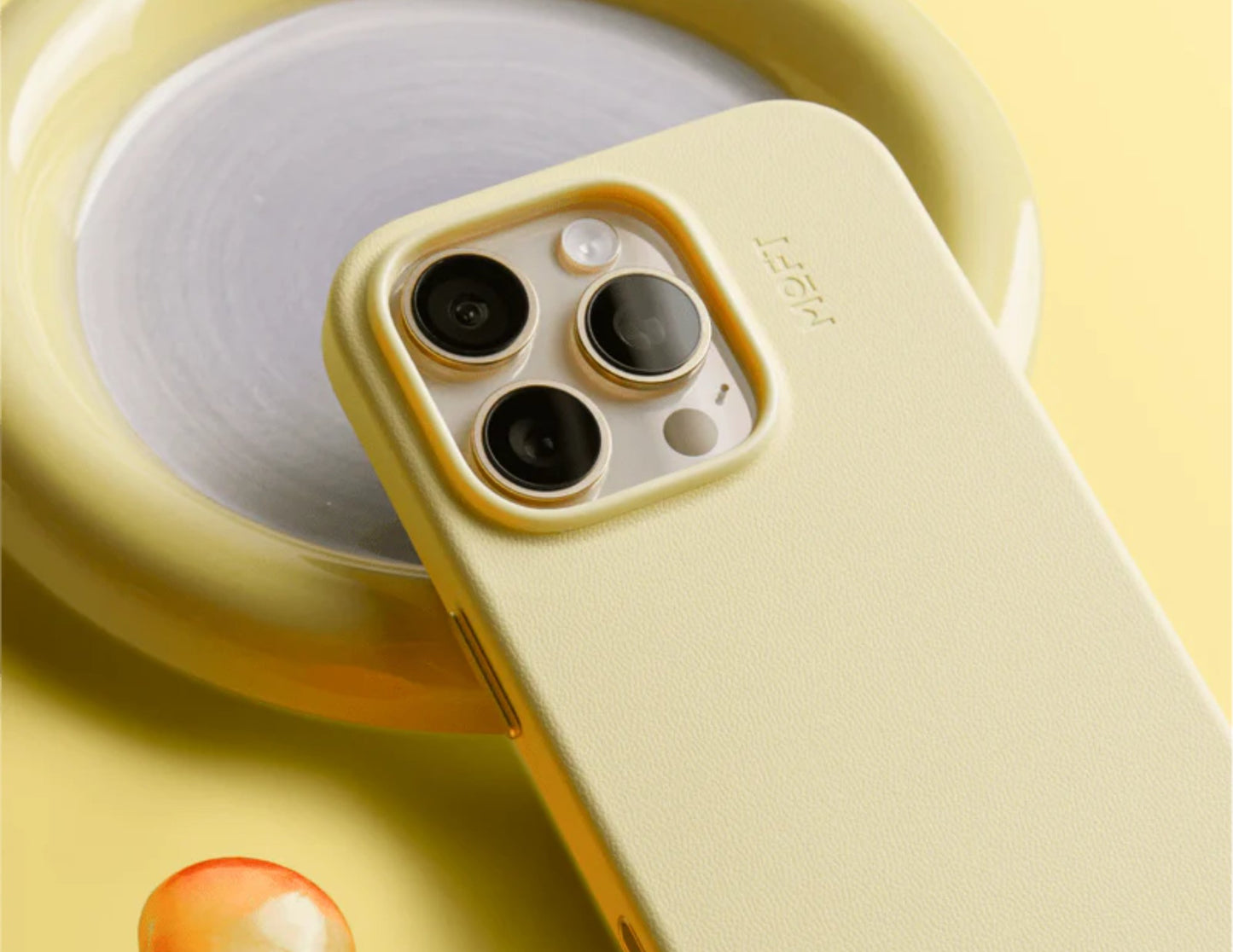 Yellow phone case with camera module on a yellow background