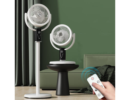 Two white oscillating fans on stands with a remote control in a room setting.