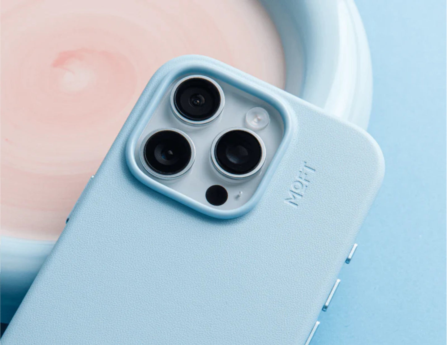 Close-up of a phone case with camera lenses on a light blue background