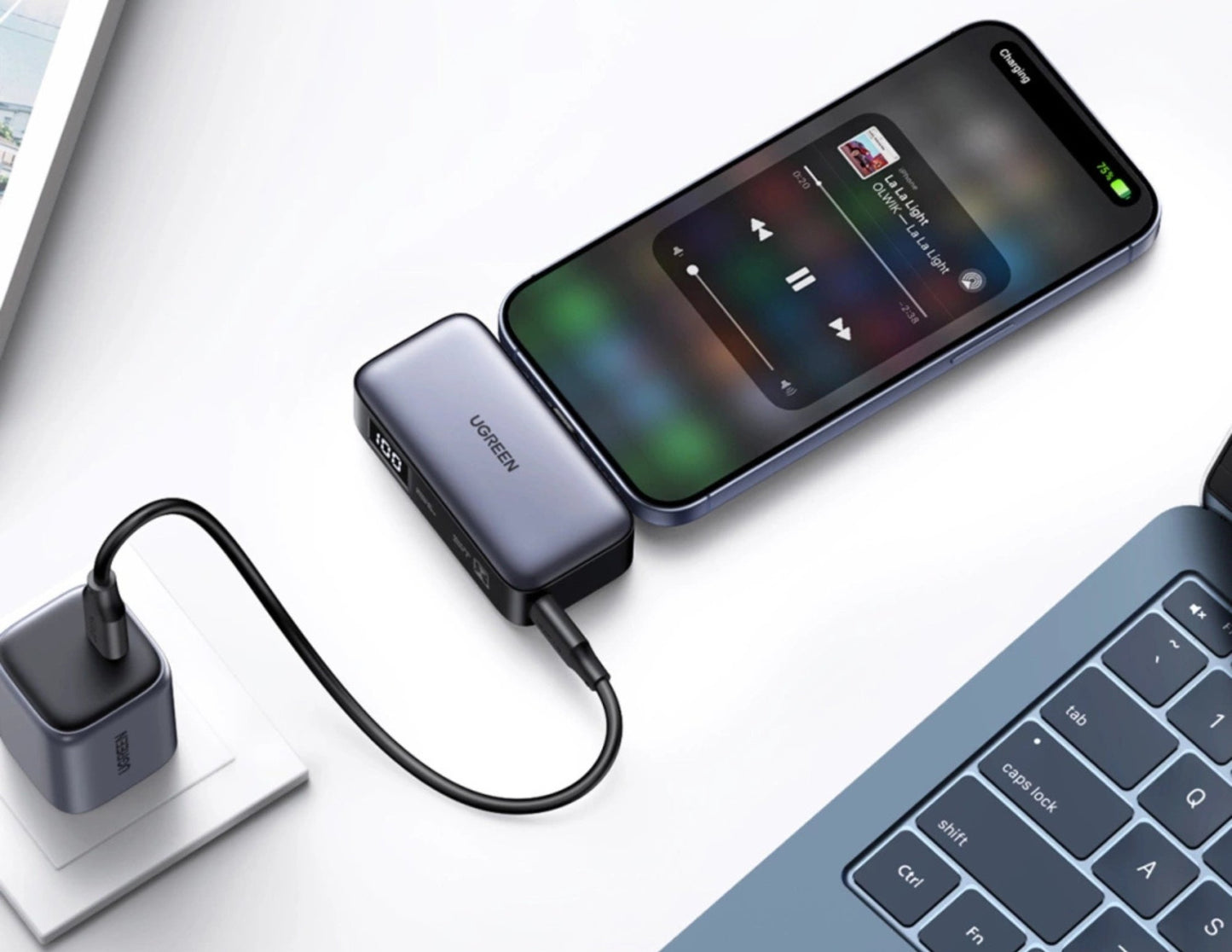 Phone connected to UGREEN Nexode 5000mAh 20W Power Bank with Built-in USB-C Connector – PB503 with laptop on a white surface