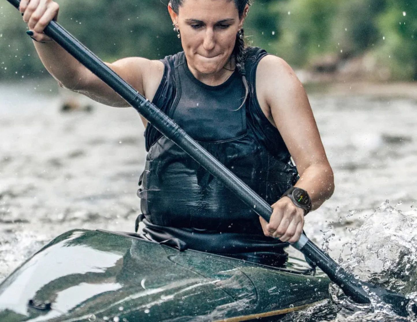 Woman paddling a kayak on a river