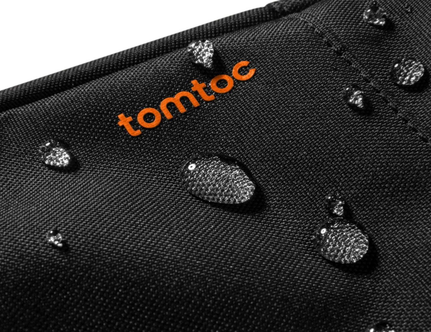 Black surface with water droplets and 'tomtoc' logo in orange.