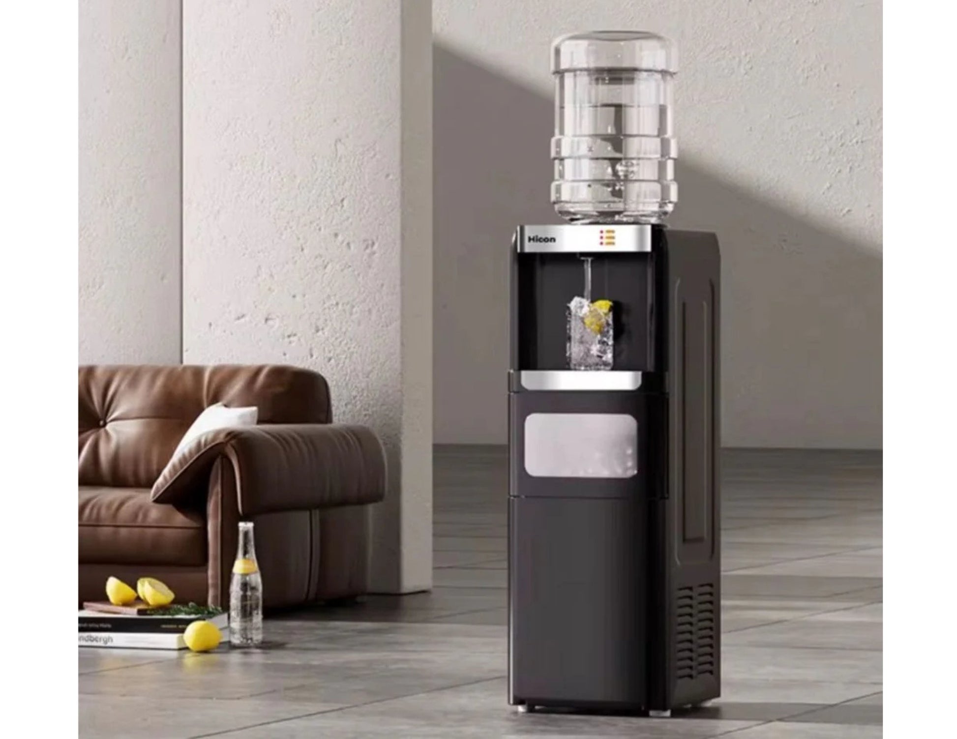 Black and silver water cooler in a room with a brown couch and a bottle of beer on a table.