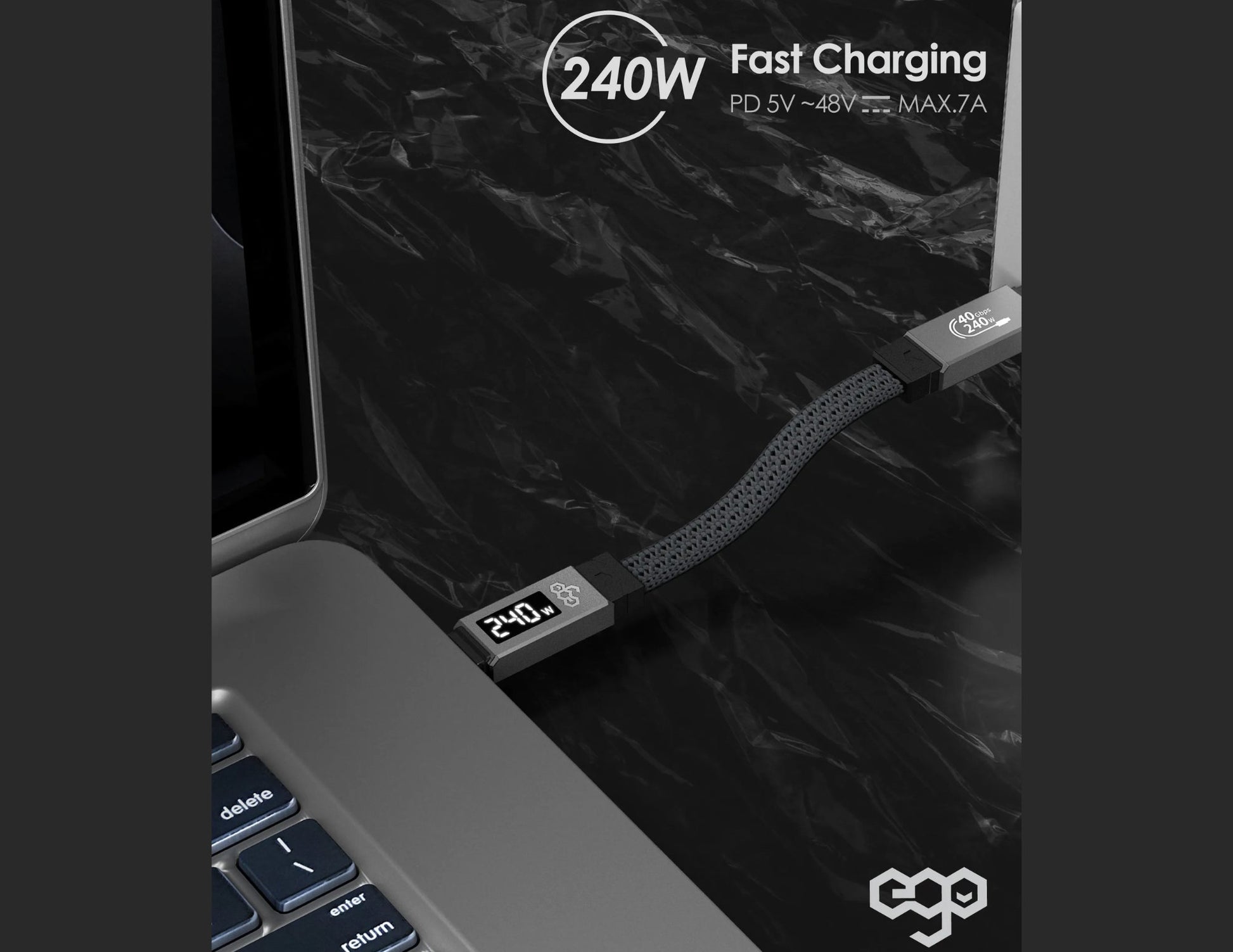 Laptop with a charging cable on a dark surface, displaying fast charging capabilities.
