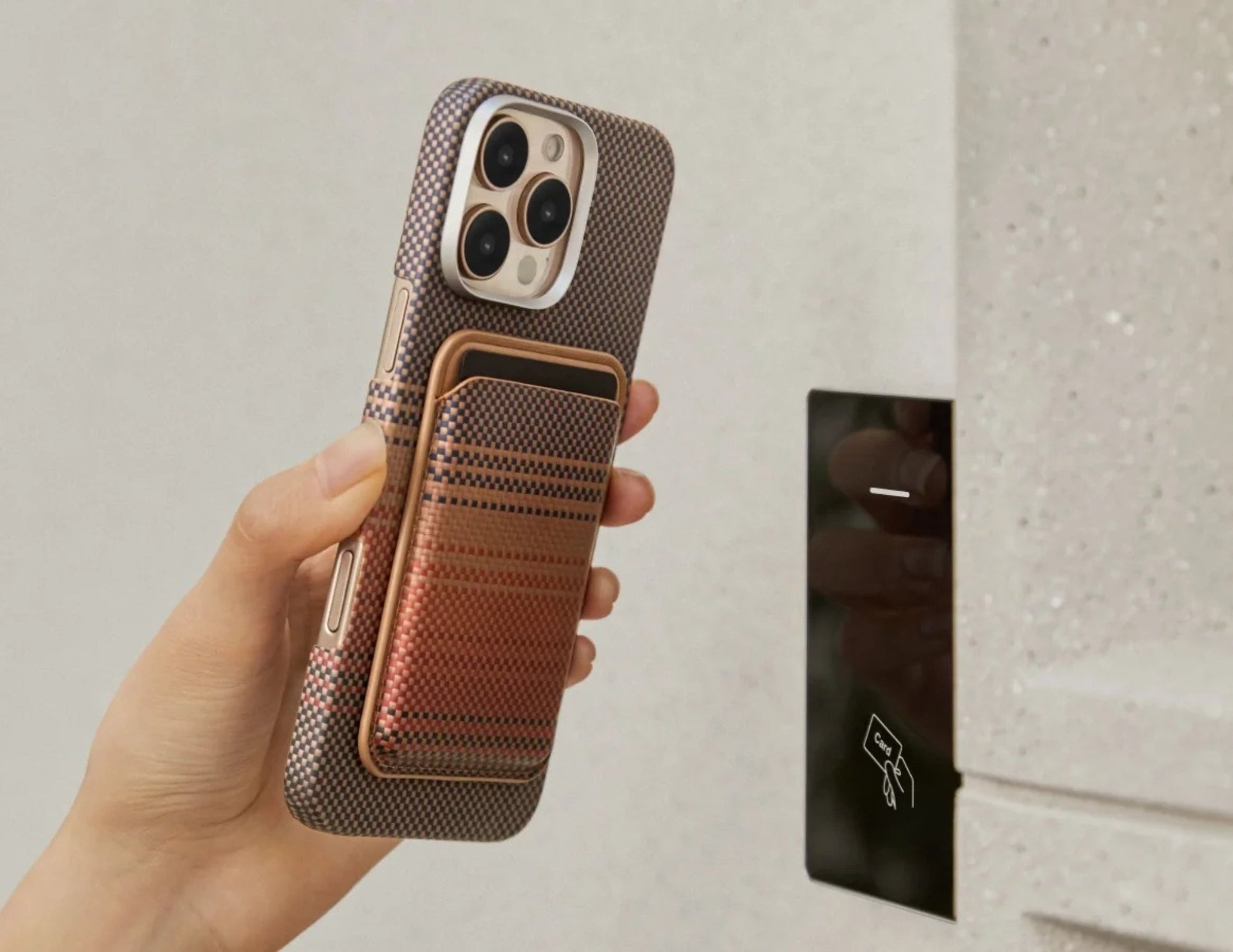 Hand holding a phone with a Pitaka MagSafe Woven Wallet – Magsafe Compatible MWW240 in front of a mirror.