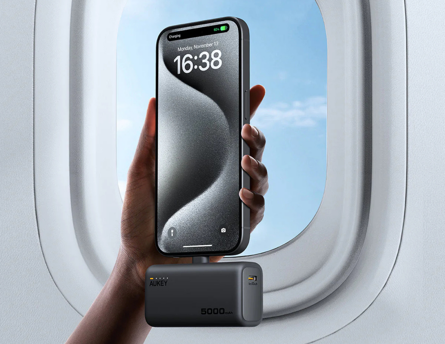 Aukey Spark Mini PB-Y59-GY in a hand showcasing its ultra-compact design.
