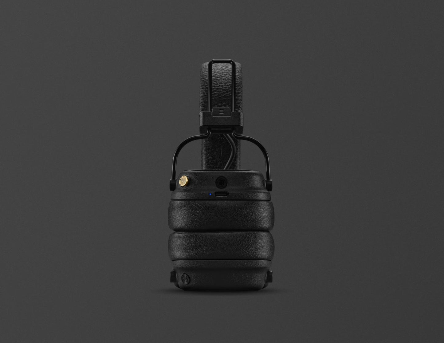 Black tactical helmet with chin strap on a dark gray background