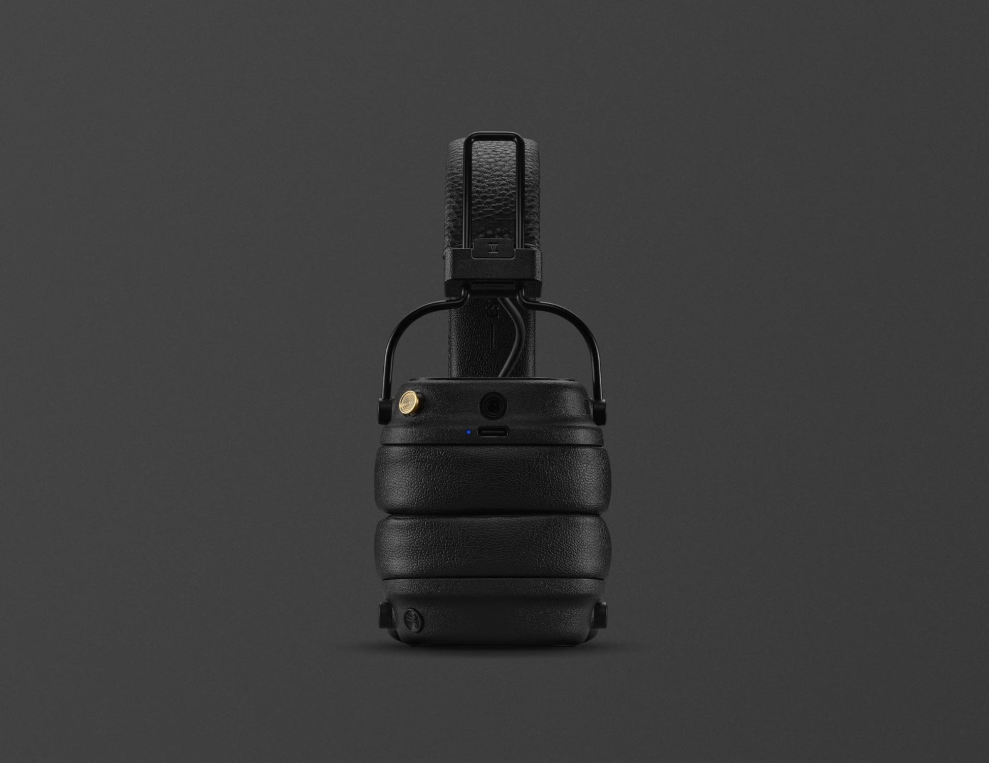 Black tactical helmet with chin strap on a dark gray background