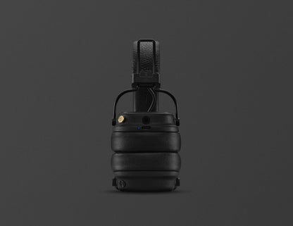 Black tactical helmet with chin strap on a dark gray background