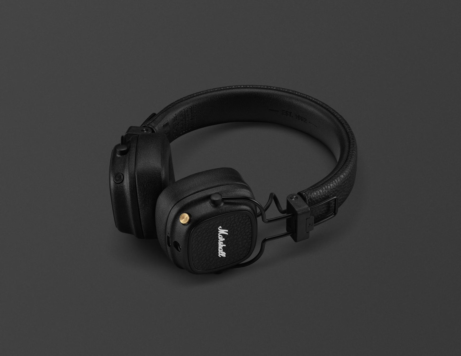 Black headphones on a dark gray background