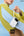 Person wearing a yellow sweater holding a white device with 'Baseus' branding against a blue sky.