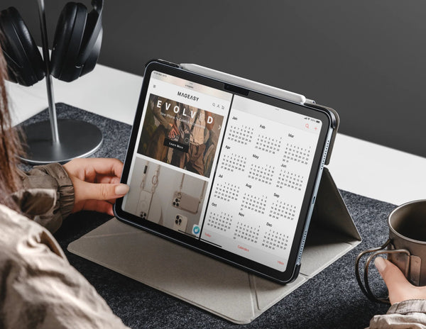Person using a tablet with a stand at a desk.