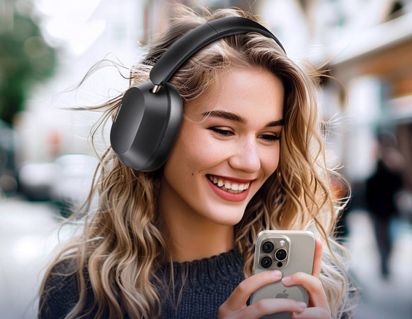 Woman wearing black headphones and using a smartphone in an urban setting
