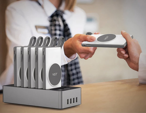 Person using a wireless charging device with WST 6-IN-1 10000mAh Power Bank Docking Station – PB932W6M