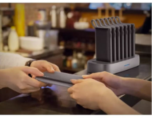Person using a Power Bank at a kitchen counter.