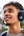 Person wearing black headphones outdoors with a blurred natural background
