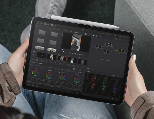 Person using a tablet with video editing software.