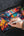 Person drawing colorful graffiti on a tablet with a stylus.