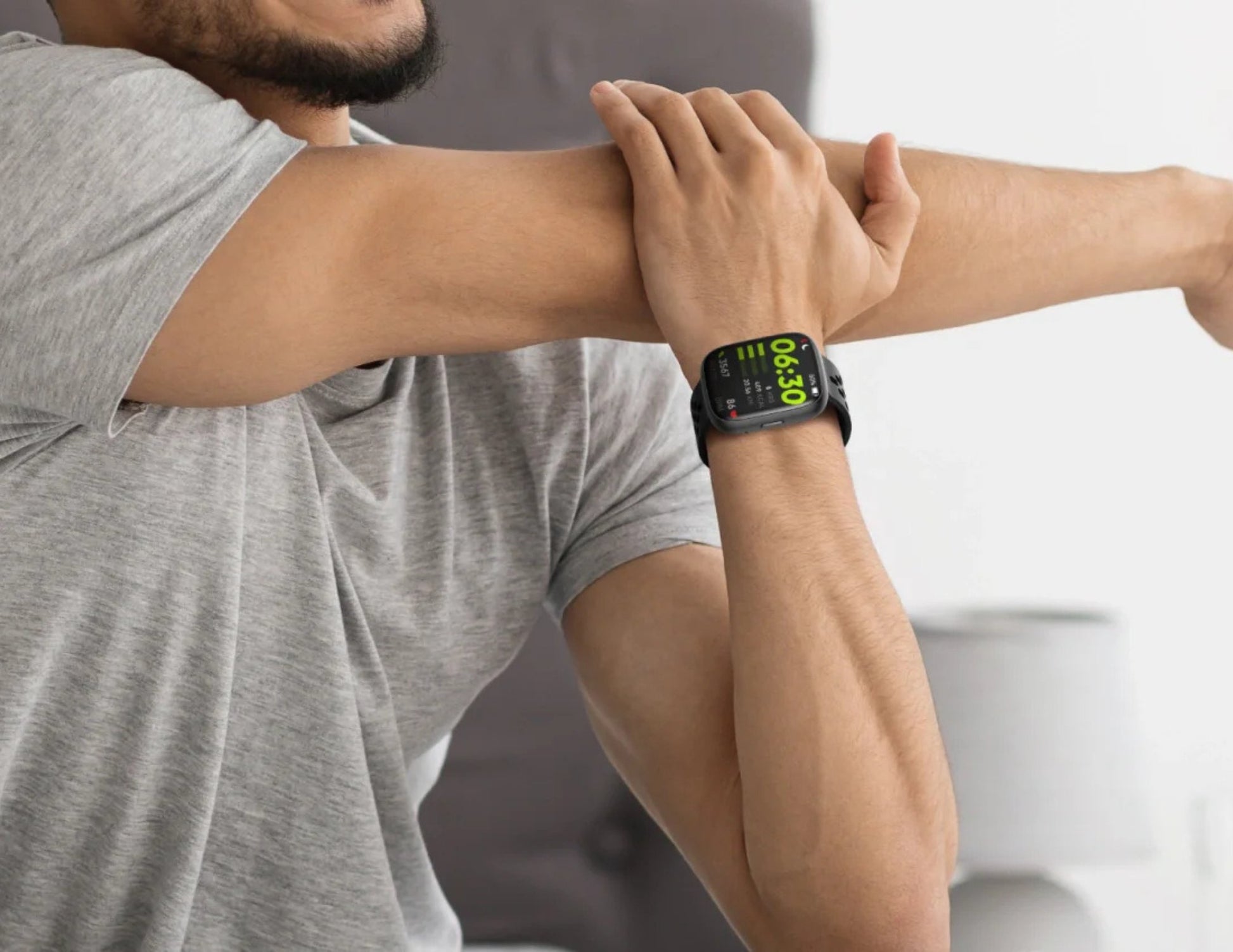 Person wearing a smartwatch on their wrist with a blurred background