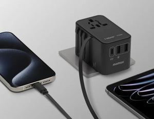 Black Momax 1‑World+ 70W GaN 3‑Port Travel Adapter with Retractable USB‑C Cable – UA18 connected to a smartphone and tablet on a light gray background.