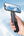 Hand holding a smartphone with a E05 Multi-purpose Travel Portable Stand (5-in-1, Magnetic, Waterproof) on the screen against a blue sky.