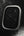 Black rectangular object with water droplets on a dark background