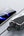 Two smartphones charging on a wireless charging pad with a gray background