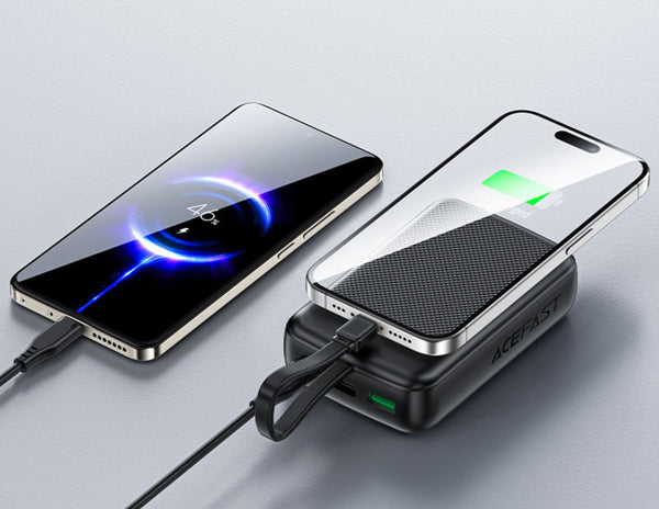 Two smartphones charging on a wireless charging pad with a gray background