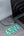 Laptop plugged into a power adapter with '65W' displayed on a gray surface.