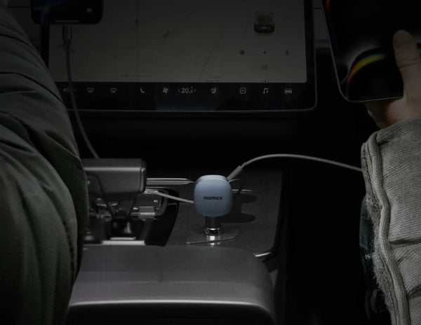 Close-up of a car's center console with a smartphone and a Momax 1-Move⁺ 2-Port Car Charger With Built-In Retractable Cable 60W (UC19E)