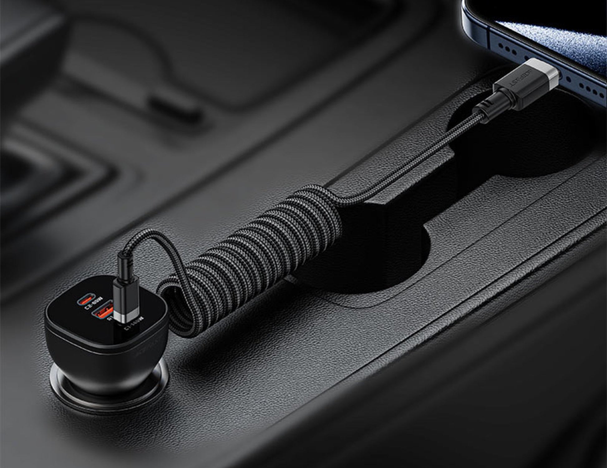 Coiled USB-C cable connected to a phone on a dark surface