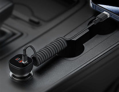 Coiled USB-C cable connected to a phone on a dark surface